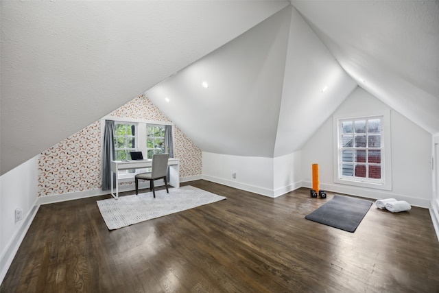 additional living space featuring lofted ceiling and dark hardwood / wood-style floors