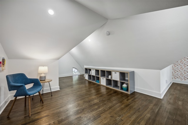 additional living space with dark hardwood / wood-style floors and vaulted ceiling