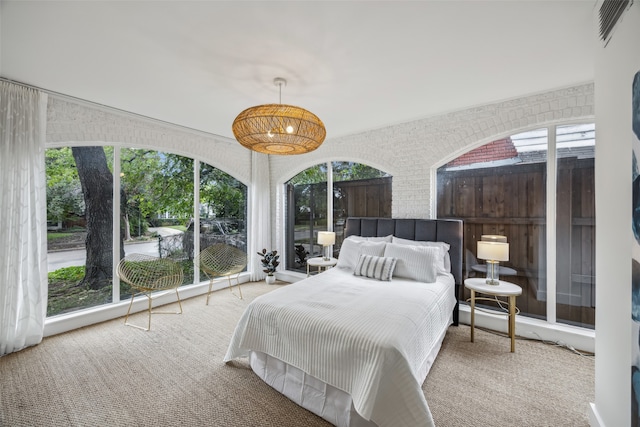 carpeted bedroom with multiple windows