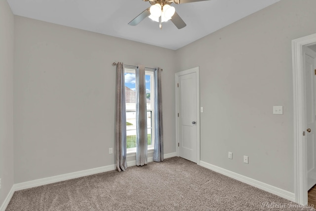 spare room with carpet floors and ceiling fan