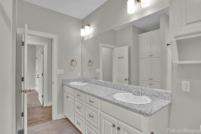 bathroom with hardwood / wood-style flooring and vanity