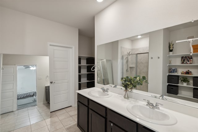 bathroom featuring tile patterned flooring, vanity, ceiling fan, and a shower with shower door