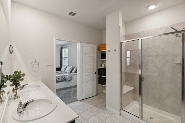 bathroom with vanity, a shower with door, and tile patterned flooring