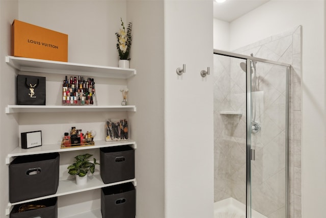 bathroom featuring a shower with door