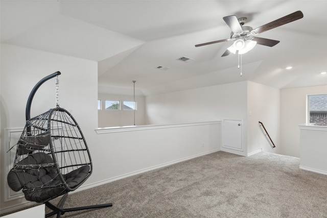 spare room with lofted ceiling, carpet flooring, and ceiling fan