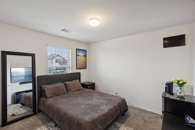 bedroom with carpet flooring and a textured ceiling