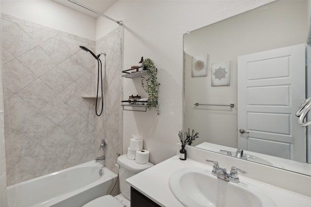 full bathroom with vanity, tiled shower / bath, and toilet