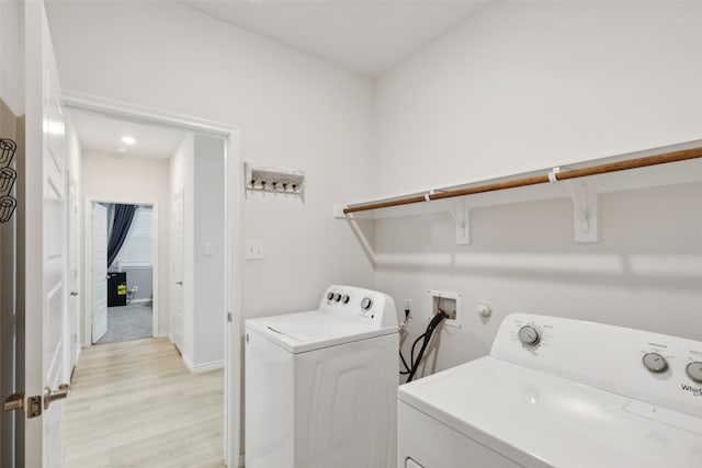 laundry area featuring light wood-type flooring and washer and dryer