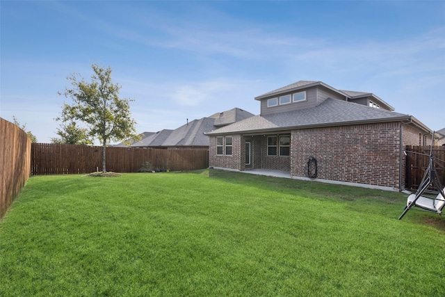 back of property featuring a patio area and a yard