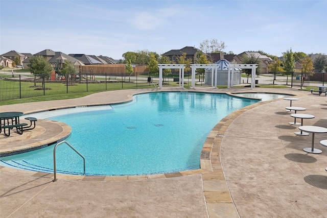 view of pool with a yard