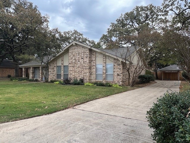 view of side of home featuring a carport and a lawn