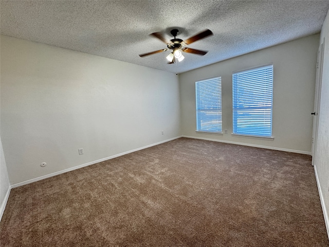 spare room featuring carpet flooring and a textured ceiling