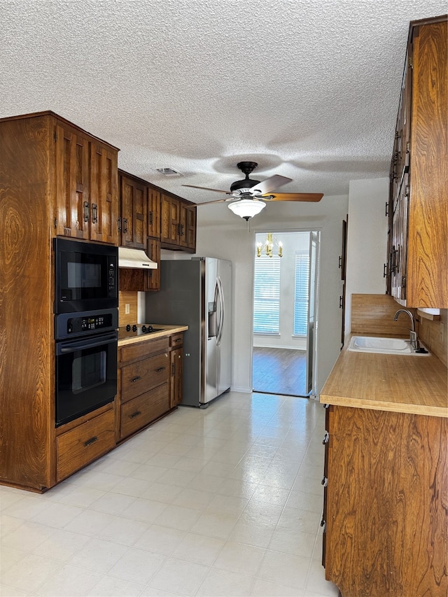 kitchen featuring black appliances, ceiling fan, sink, and a textured ceiling