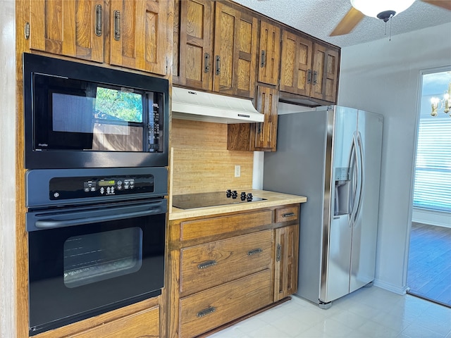 kitchen with black appliances, ceiling fan with notable chandelier, and a textured ceiling