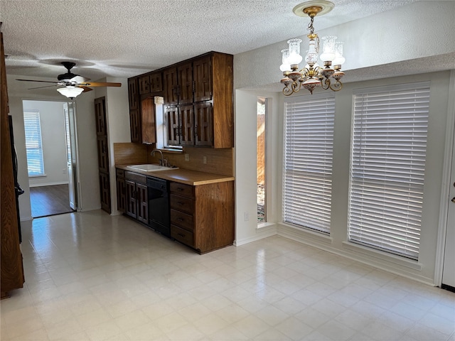 kitchen featuring sink, a healthy amount of sunlight, ceiling fan with notable chandelier, and black dishwasher