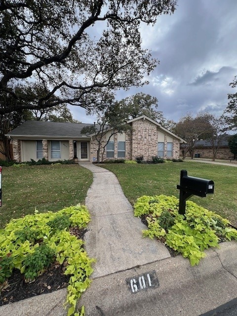 ranch-style house with a front lawn