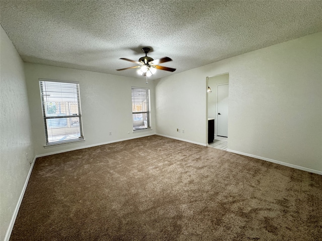 carpeted empty room featuring a textured ceiling and ceiling fan