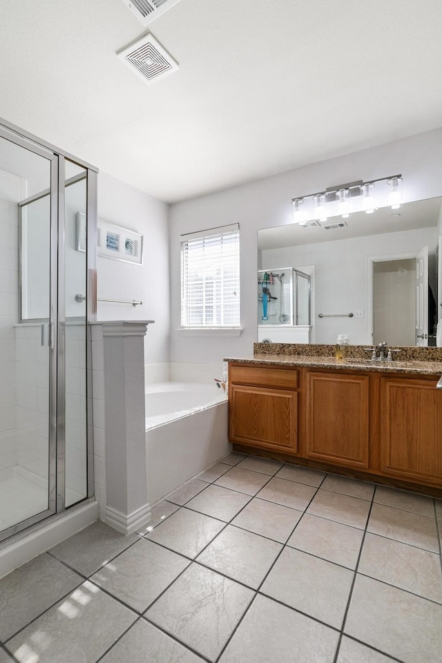 bathroom featuring vanity, tile patterned floors, and separate shower and tub