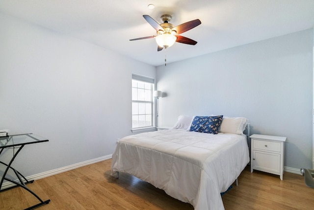 bedroom with ceiling fan and light hardwood / wood-style flooring