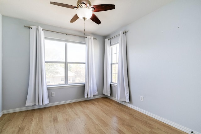 spare room featuring ceiling fan, plenty of natural light, and light hardwood / wood-style floors