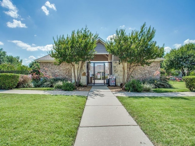 obstructed view of property featuring a front yard