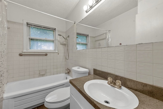 full bathroom featuring tile walls, vanity, a textured ceiling, toilet, and shower / tub combo with curtain