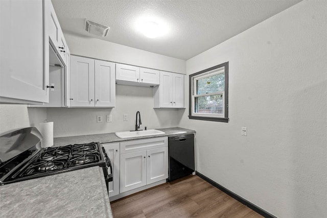 kitchen with black appliances, white cabinetry, a textured ceiling, dark hardwood / wood-style floors, and sink