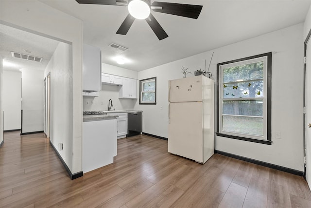 kitchen featuring white cabinetry, light hardwood / wood-style floors, black dishwasher, and white fridge