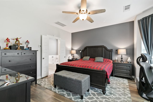 bedroom with connected bathroom, ceiling fan, and dark hardwood / wood-style floors