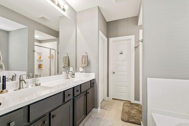 bedroom featuring a closet, ceiling fan, hardwood / wood-style flooring, a walk in closet, and ensuite bathroom