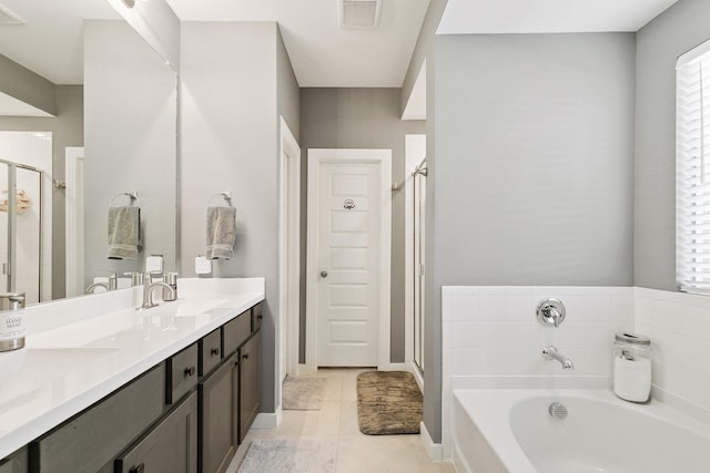 bathroom featuring vanity, tile patterned flooring, and separate shower and tub