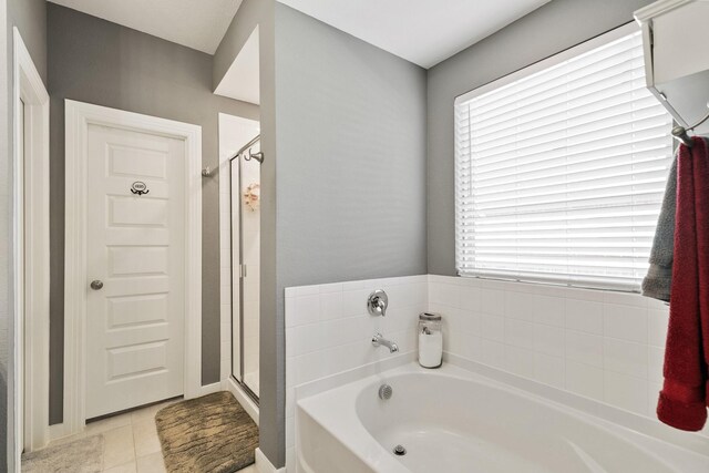 bathroom featuring shower with separate bathtub, tile patterned floors, and vanity