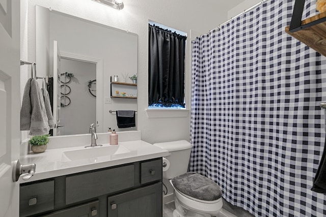 bathroom featuring toilet and vanity