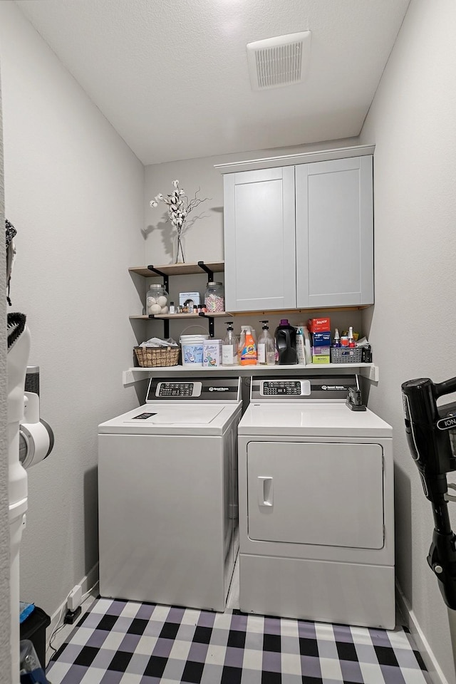 laundry area with cabinets and independent washer and dryer