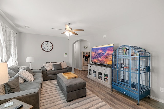 living room with ceiling fan and hardwood / wood-style flooring