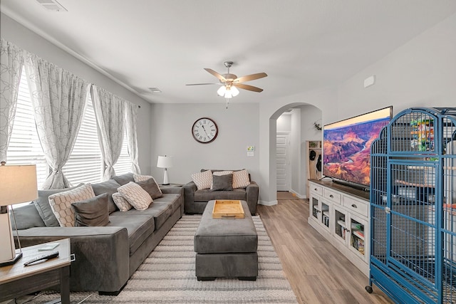 living room with hardwood / wood-style floors and ceiling fan