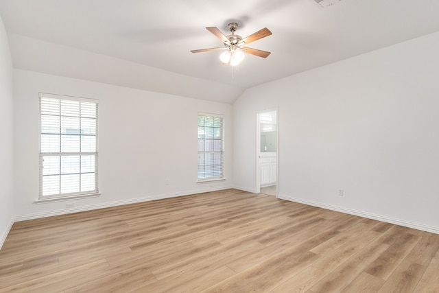 unfurnished room featuring light hardwood / wood-style flooring, ceiling fan, and vaulted ceiling