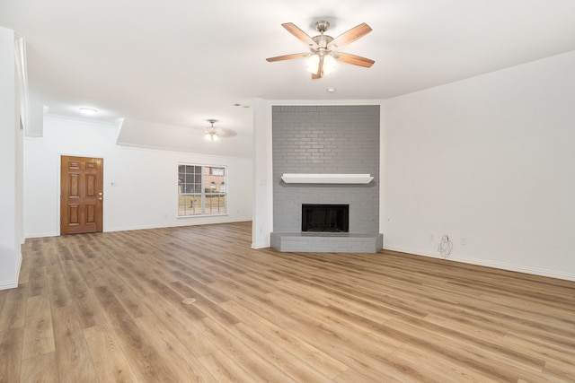 unfurnished living room with ceiling fan, crown molding, light hardwood / wood-style floors, and a brick fireplace