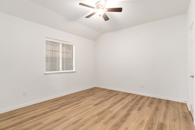 spare room with light wood-type flooring, lofted ceiling, and ceiling fan