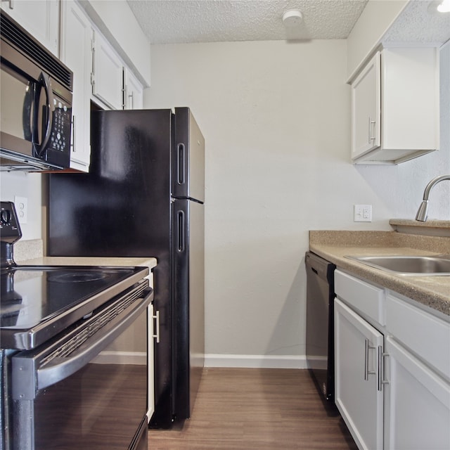 kitchen featuring white cabinetry, sink, and black appliances