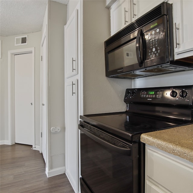 kitchen featuring black appliances, dark hardwood / wood-style flooring, a textured ceiling, and white cabinets