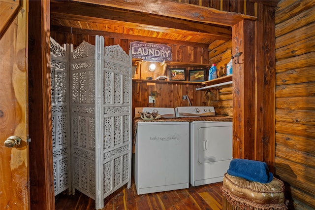 clothes washing area featuring washing machine and dryer and dark hardwood / wood-style floors