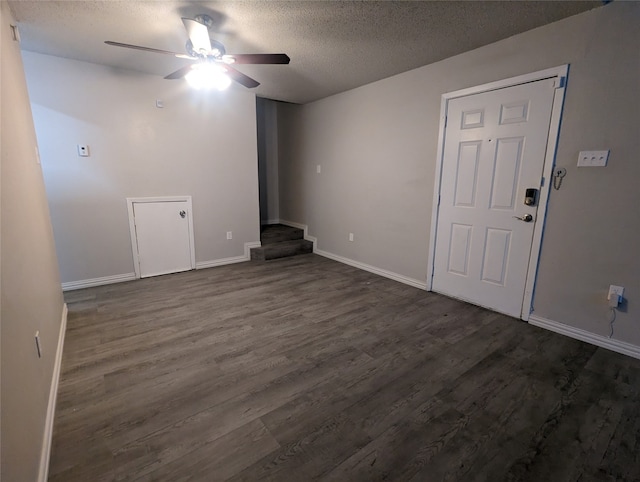 interior space with dark hardwood / wood-style flooring, a textured ceiling, and ceiling fan