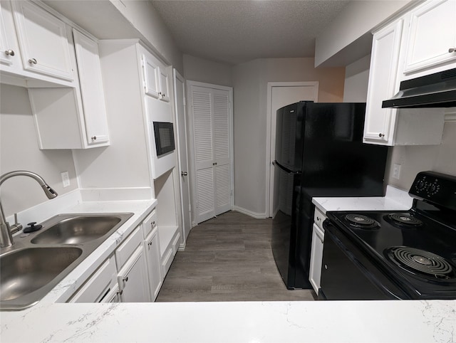 kitchen featuring white cabinetry, a textured ceiling, dark hardwood / wood-style flooring, sink, and electric range