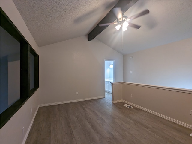 unfurnished room featuring hardwood / wood-style floors, ceiling fan, a textured ceiling, and lofted ceiling with beams