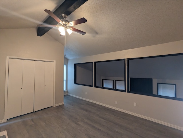 unfurnished bedroom with hardwood / wood-style floors, vaulted ceiling with beams, and ceiling fan