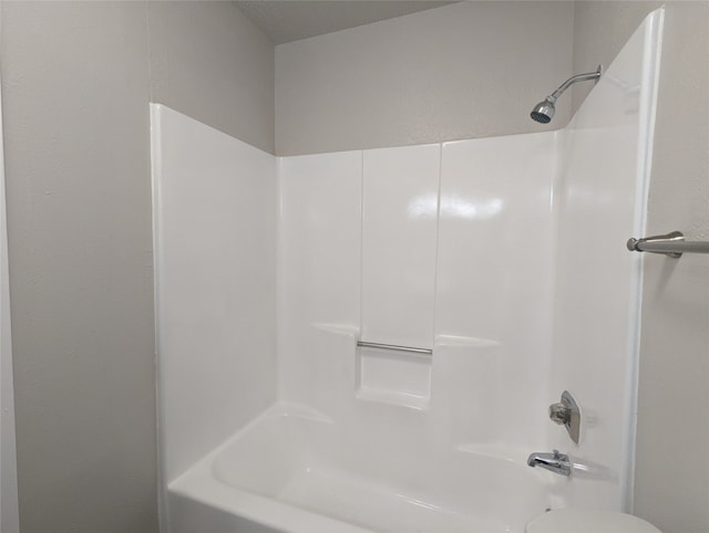 bathroom with shower / washtub combination and toilet