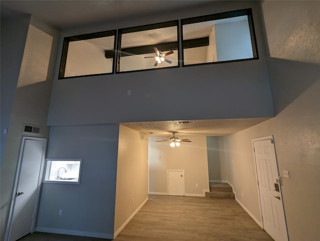 interior space with a textured ceiling, hardwood / wood-style flooring, and sink