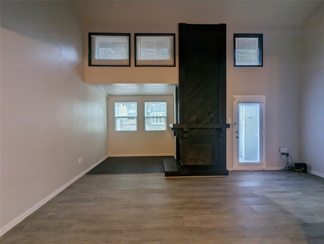 unfurnished living room with a fireplace and dark hardwood / wood-style floors