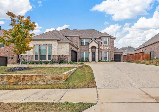 view of front of house with a garage and a front yard